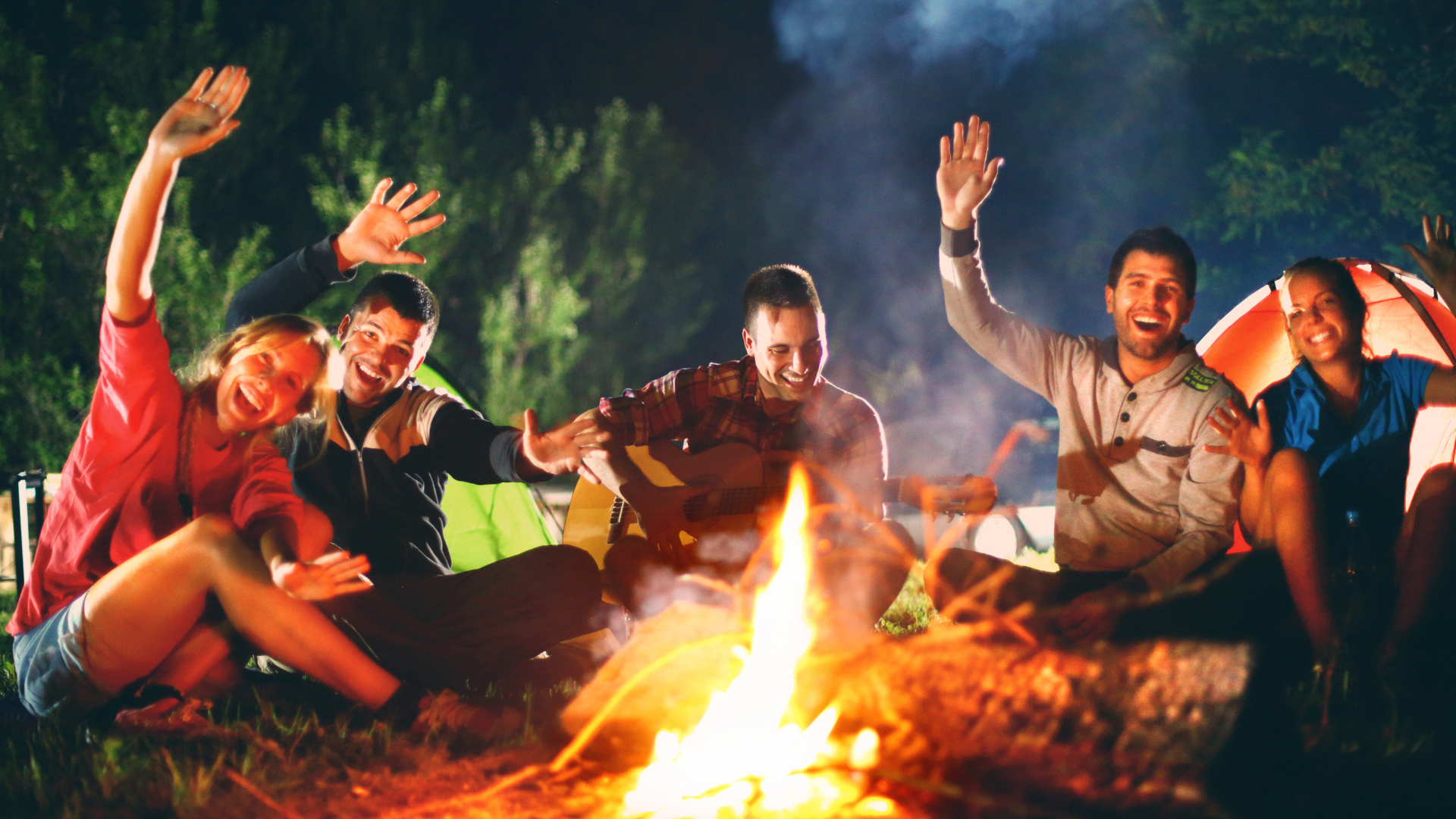 Adults enjoying life over a campfire