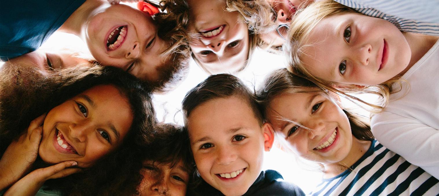 School student in a circle, looking down at the camera,